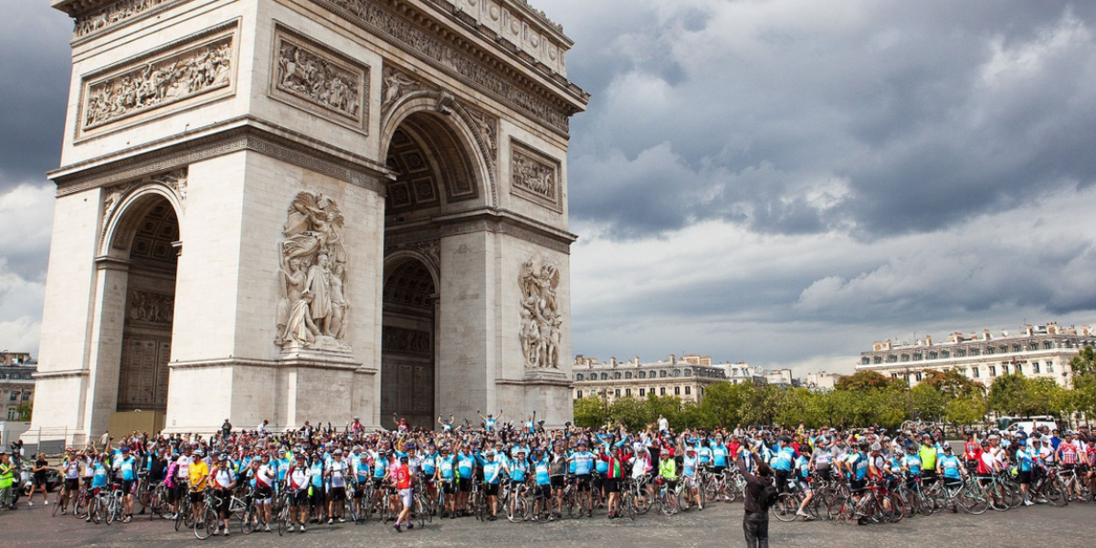 Photo of cyclists on London to Paris cycle at the Arc de Triomphe